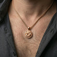 Load image into Gallery viewer, Rose gold plated wolf necklace with dual wolf relief, flowing fur composition, and elegant medallion silhouette worn on the neck in a refined lifestyle shot with a warm and sophisticated presentation