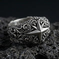 Load image into Gallery viewer, Oxidized sterling silver North Star signet ring on black volcanic stone, hand-carved compass star with deep shadowed scrollwork for bold contrast.