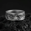 Load image into Gallery viewer, Oxidized sterling silver Benjamin Franklin eyes band ring on black volcanic stone, deepened shadows emphasizing the facial relief and intense gaze.