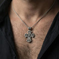 Load image into Gallery viewer, Holy Trinity cross pendant worn on the neck, showing scale and how the double-sided design sits flat on the chest.
