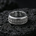 Load image into Gallery viewer, 925 silver fleur de lis ring on black volcanic stone, polished silver rim framing the engraved lattice and fleur details.