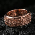 Load image into Gallery viewer, Floral spinner band on volcanic stone with a rose gold plated look, showing crisp daisy detailing and smooth rounded edges.