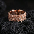 Load image into Gallery viewer, Daisy flower band ring on volcanic stone with a rose gold plated look, showing crisp floral relief and a bold comfort-fit profile.