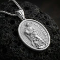 Load image into Gallery viewer, A polished 925 sterling silver Saint John the Evangelist pendant on volcanic rock, oval saint medal with detailed relief.