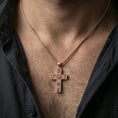 Load image into Gallery viewer, Rose gold plated cross pendant with rose engravings worn on the neck in a detailed lifestyle shot with a warm and refined presentation