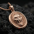 Load image into Gallery viewer, Rose gold plated roaring gorilla necklace with fierce open-mouth primate relief, detailed facial texture, and elegant oval medallion form resting on volcanic rock in an elegant close-up product presentation