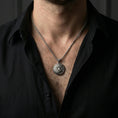 Load image into Gallery viewer, Oxidized sleeping tiger pendant with curled jungle cat design worn on the neck in a lifestyle jewelry shot, styled against the chest for a bold and symbolic statement look