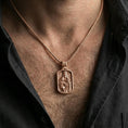 Load image into Gallery viewer, Rose gold plated religious Madonna pendant with baby Jesus worn on the neck in a refined lifestyle shot with a warm and elegant presentation