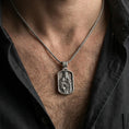 Load image into Gallery viewer, Oxidized Virgin Mary and Child pendant worn on the neck in a lifestyle jewelry shot, styled against the chest for a devotional and timeless look