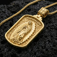 Load image into Gallery viewer, Gold plated Our Lady of Guadalupe medal pendant with detailed Marian figure, decorative border, and Guadalupe lettering showcased on black volcanic rock in a refined macro jewelry image