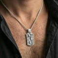 Load image into Gallery viewer, Polished silver aquarium necklace with detailed fish relief and underwater plant motifs worn on the neck in a close lifestyle frame, highlighting the rectangular medallion form and aquatic craftsmanship