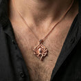 Load image into Gallery viewer, Rose gold plated spider necklace with realistic arachnid silhouette, detailed body structure, and elegant dark nature motif worn on the neck in a refined lifestyle shot with a warm and dramatic presentation