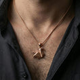 Load image into Gallery viewer, Rose gold plated geometric swan necklace with origami-inspired folded form, angular minimalist design, and elegant bird silhouette worn on the neck in a refined lifestyle shot with a warm and sophisticated presentation