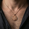Load image into Gallery viewer, Rose gold plated Saint George dragon pendant worn on the neck in a refined lifestyle shot with a warm and powerful presentation