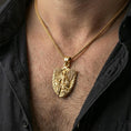 Load image into Gallery viewer, Gold plated Archangel Michael necklace with armored angel design and shield motif worn on the neck in a premium lifestyle composition with strong Christian jewelry styling