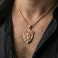 Load image into Gallery viewer, Rose gold plated Saint Michael guardian pendant with sword, wings, and shield form worn on the neck in a refined lifestyle shot with a warm and powerful presentation