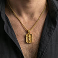Load image into Gallery viewer, Gold plated religious Jesus necklace with ascending figure and angel details worn on the neck in a premium lifestyle composition with classic devotional jewelry styling