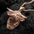 Load image into Gallery viewer, Rose gold plated buffalo head pendant necklace on dark volcanic rock, photographed in a detailed premium studio macro view.