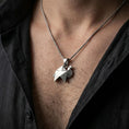 Load image into Gallery viewer, Oxidized origami camel pendant necklace worn on the neck, styled in a dark lifestyle portrait with an open shirt and masculine presentation.
