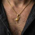 Load image into Gallery viewer, Gold plated origami flamingo pendant necklace worn on the neck, captured on a human model in a premium dark-toned lifestyle frame.