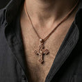 Load image into Gallery viewer, Rose gold plated Archangel Michael cross pendant with shield detail and gothic scrollwork worn on the neck in a refined lifestyle shot with a warm and powerful presentation