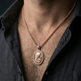 Load image into Gallery viewer, Rose gold plated Virgin Mary medallion with sacred heart and star halo worn on the neck in a refined lifestyle shot with a warm and elegant presentation