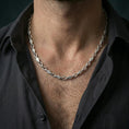 Load image into Gallery viewer, Polished silver evil eye link chain necklace worn on the neck, shown against the chest in a clean and elegant everyday wear composition.