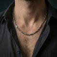 Load image into Gallery viewer, Oxidized evil eye link chain necklace worn on the neck, styled in a dark lifestyle portrait with an open shirt and masculine presentation.