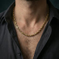 Load image into Gallery viewer, Gold plated evil eye link chain necklace worn on the neck, captured on a human model in a premium dark-toned lifestyle frame.