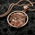 Load image into Gallery viewer, Rose gold plated religious Jesus pendant with flowing hair, crown of thorns, and circular portrait design resting on volcanic rock in an elegant close-up product presentation