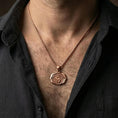 Load image into Gallery viewer, Rose gold plated spiritual chakra pendant with centered Om design and lotus-inspired silhouette worn on the neck in a refined lifestyle shot with a warm and balanced presentation