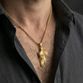 Load image into Gallery viewer, Gold plated angel wing pendant worn on the neck in a premium lifestyle composition with refined symbolic jewelry styling