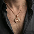 Load image into Gallery viewer, Rose gold plated spiritual chakra pendant with geometric heart chakra symbol and layered floral border worn on the neck in a refined lifestyle shot with a warm and balanced presentation