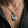 Load image into Gallery viewer, Polished silver Jesus medallion with seated Christ relief worn on the neck in a close lifestyle frame, highlighting the framed silhouette and detailed sacred portrait