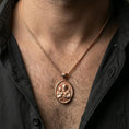 Load image into Gallery viewer, Rose gold plated Saint Joseph pendant with Child Jesus and haloed devotional portrait worn on the neck in a refined lifestyle shot with a warm and elegant presentation