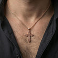 Load image into Gallery viewer, Rose gold plated religious Celtic cross necklace with detailed openwork pattern worn on the neck in a refined lifestyle shot with a warm and elegant presentation