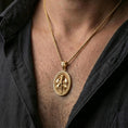 Load image into Gallery viewer, Gold plated Knight Templar pendant with armored knight motif and oval medallion form worn on the neck in a premium lifestyle composition with strong historical jewelry styling