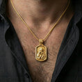 Load image into Gallery viewer, Gold plated Virgin Mary necklace with Baby Jesus motif worn on the neck in a premium lifestyle composition with classic Christian jewelry styling
