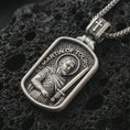 Load image into Gallery viewer, Sterling silver Saint Martin of Tours pendant necklace with an oxidized finish resting on textured volcanic rock, captured in a close-up premium studio composition.