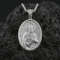 Load image into Gallery viewer, Polished silver Saint Peter pendant necklace displayed on black volcanic rock, shown in a refined macro product shot with detailed saint figure and key relief.