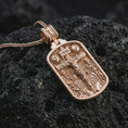 Load image into Gallery viewer, Rose gold plated Jesus INRI crucifixion pendant necklace on dark volcanic rock, photographed in a detailed premium studio macro view.