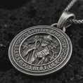 Load image into Gallery viewer, Sterling silver Saint Benedict medal pendant necklace with an oxidized finish resting on textured volcanic rock, captured in a close-up premium studio composition.