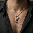 Load image into Gallery viewer, Polished silver snake necklace with detailed scale texture, wrapped serpent form, and branch detail worn on the neck in a close lifestyle frame, highlighting the sculptural symbolic design
