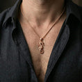 Load image into Gallery viewer, Rose gold plated seahorse necklace with detailed marine relief and curled tail design worn on the neck in a refined lifestyle shot with a warm and elegant presentation