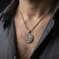 Load image into Gallery viewer, Oxidized koi fish pendant with twin fish motif worn on the neck in a lifestyle jewelry shot, styled against the chest for a balanced and nature-inspired look