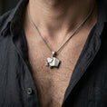 Load image into Gallery viewer, Oxidized origami elephant pendant worn on the neck in a lifestyle jewelry shot, styled against the chest for a bold and minimalist statement look