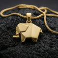 Load image into Gallery viewer, Gold plated origami elephant pendant with geometric folded detailing, minimalist animal shape, and contemporary sculptural form showcased on black volcanic rock in a refined macro jewelry image