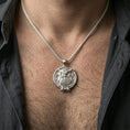 Load image into Gallery viewer, Polished silver owl necklace with circular medallion design and detailed bird relief worn on the neck in a close lifestyle frame, highlighting the wise owl motif and refined craftsmanship