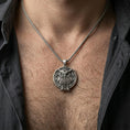 Load image into Gallery viewer, Oxidized owl pendant with engraved feather details worn on the neck in a lifestyle jewelry shot, styled against the chest for a symbolic and nature-inspired statement look
