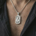 Load image into Gallery viewer, Polished silver Saint Paul dog tag pendant necklace worn on the neck, shown against the chest in a clean and elegant everyday wear composition.